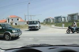 Intersection with an SUV, a truck and a motorcycle