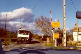 Narrow level crossing with a truck approaching