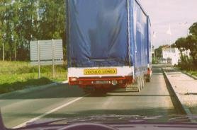 Large blue truck directly ahead filling the lane