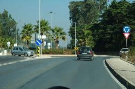 Roundabout with cars circulating and a give way sign