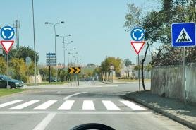 Roundabout approach with zebra crossing and give way sign