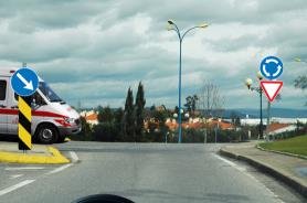 Ambulance waiting at a roundabout entry