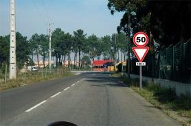 Speed limit 50 sign mounted above a give way sign