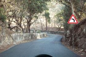 Sharp bend warning sign on a winding road